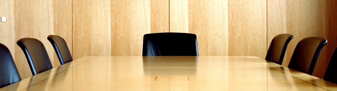 Photo of a conference room representing a management meeting